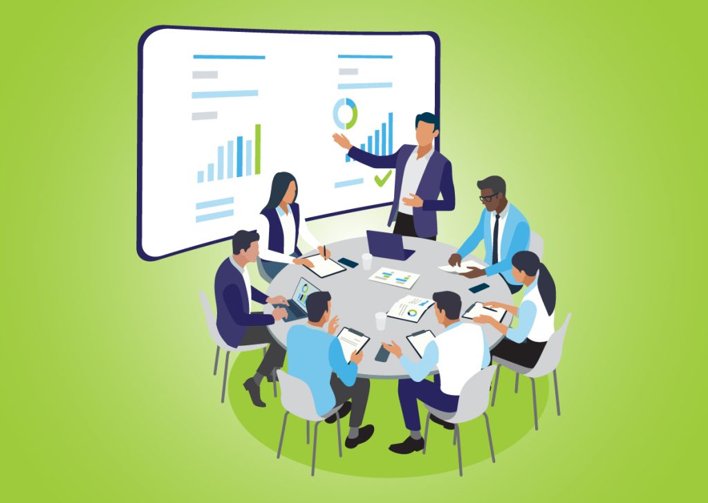 A group of employees gather around a table to discuss goals, objectives, and metrics.